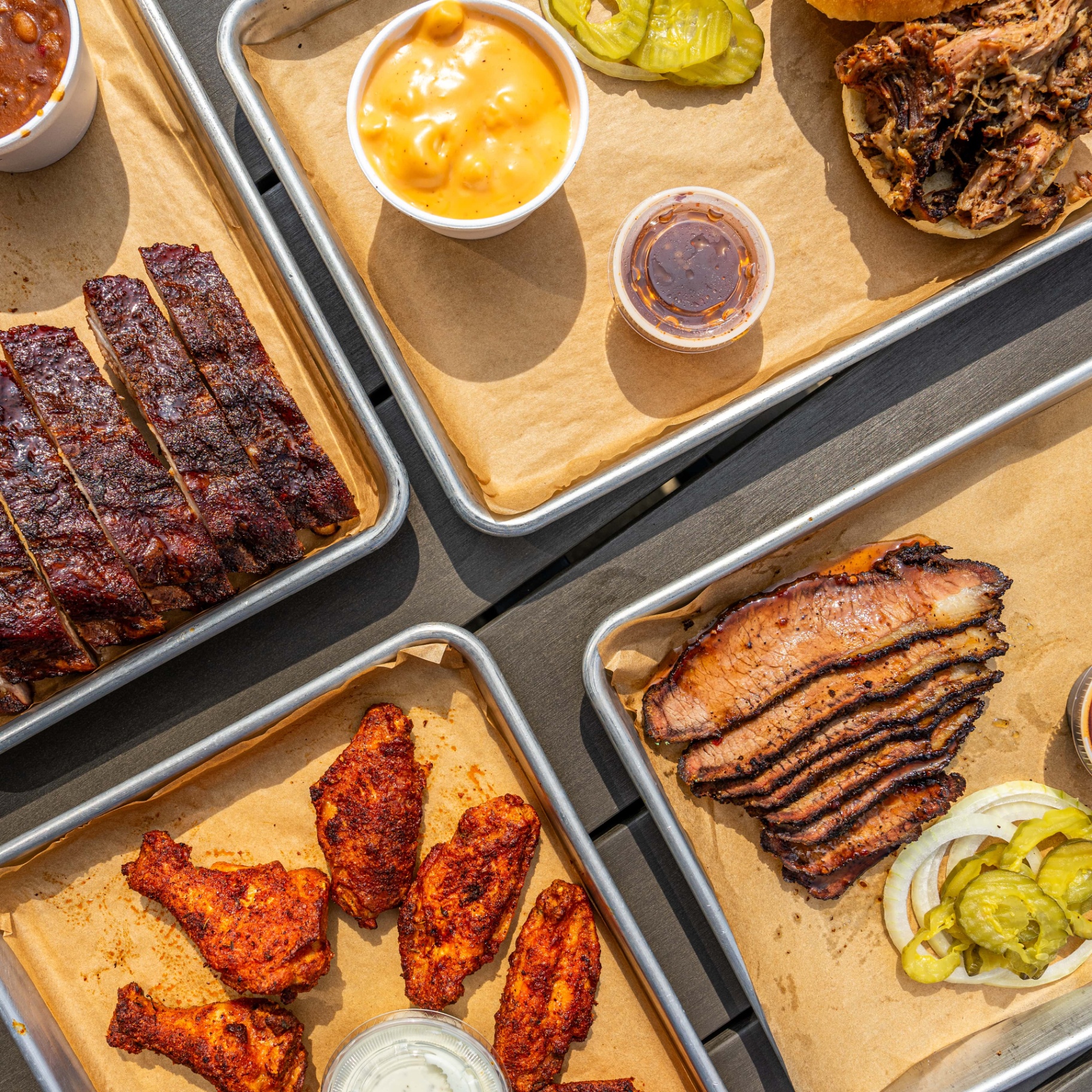 O'B Que's BBQ spread — ribs, brisket, wings, mac and cheese